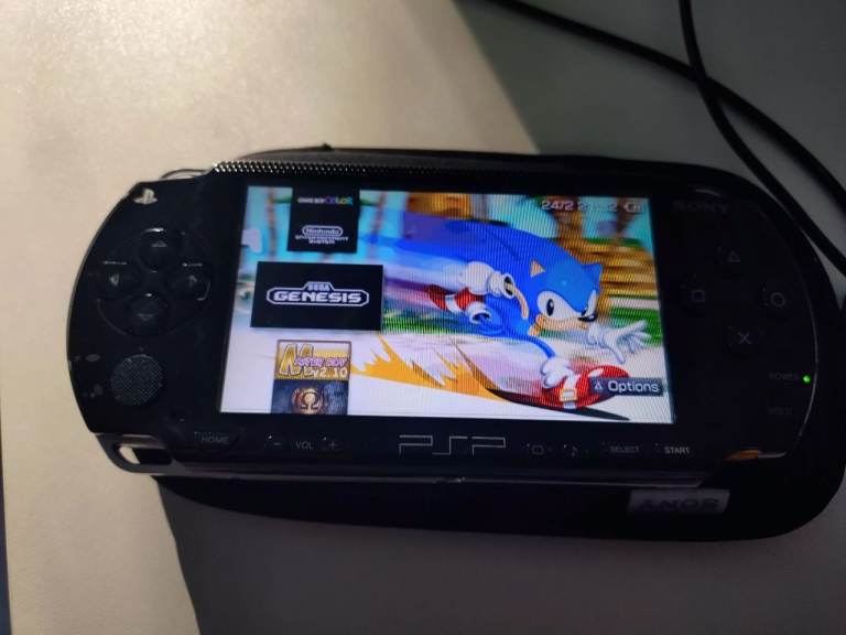 PSP 1003 with OSTENT battery, USB DATA cable & 64gb memory card.