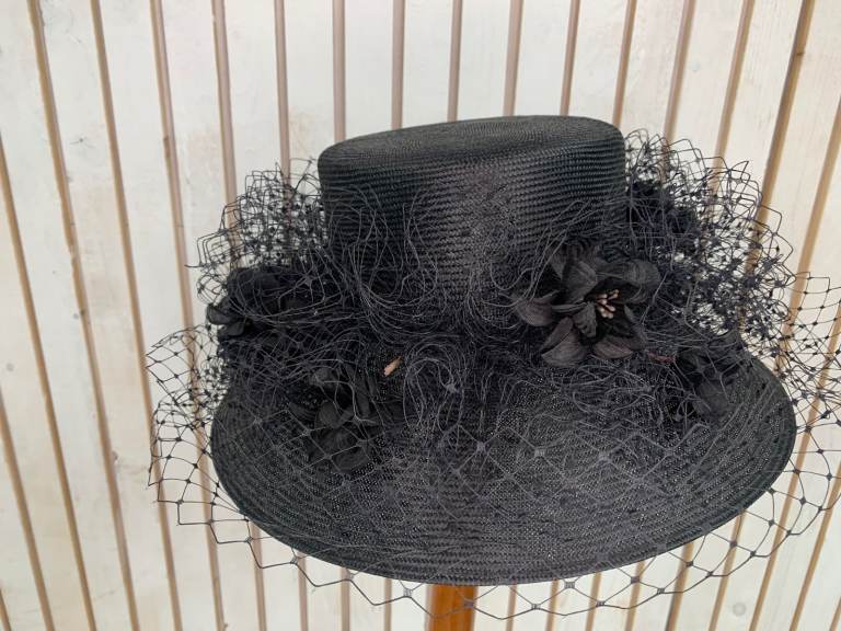 Graham Smith floral fascinator with a wide brim.