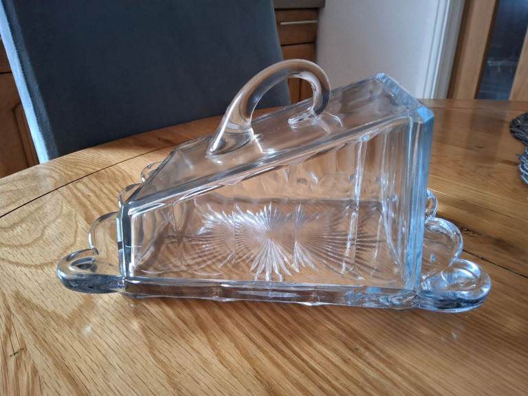 A large glass butter dish