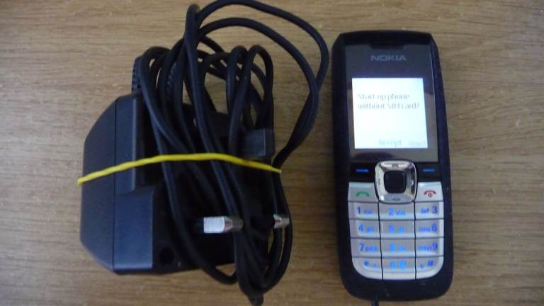 Nokia mobile phone, not smart, just a phone, with charger.