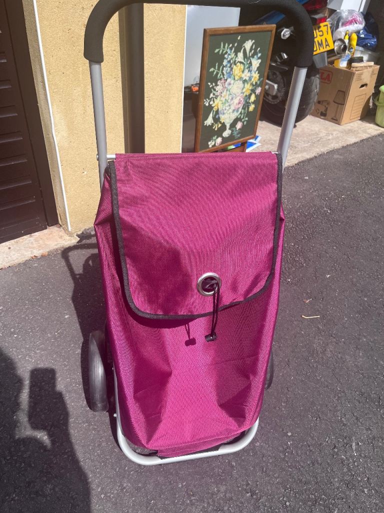 Purple shopping trolley / fold down seat. Light aluminium frame on 2 wheels 