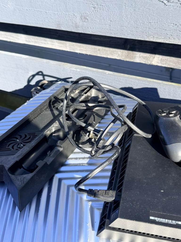 PS4 with 2 controllers and fan cooler stand 