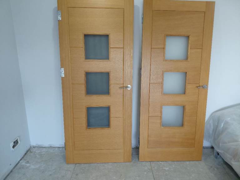 Two Internal Oak glazed doors complete with handles and hinges
