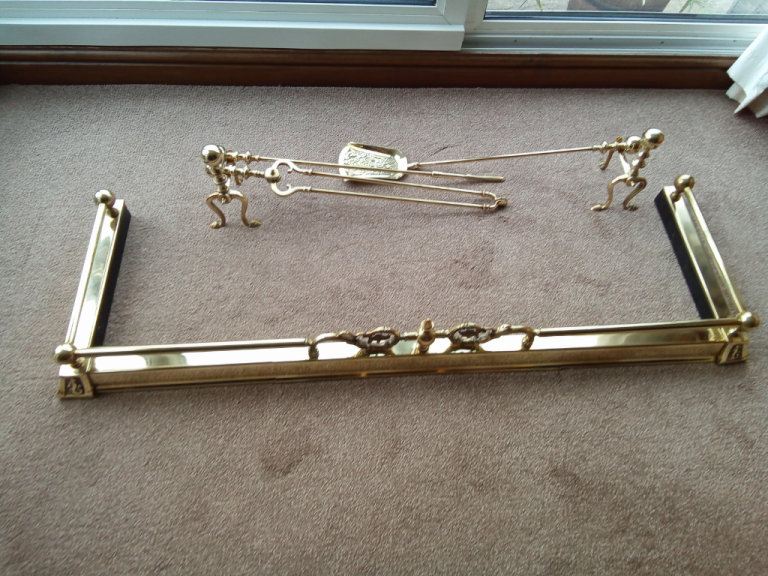 Sandringham style brass fender with fire dogs and accessories.