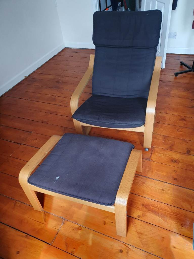 Black fabric Ikea Poang chair and foot stool