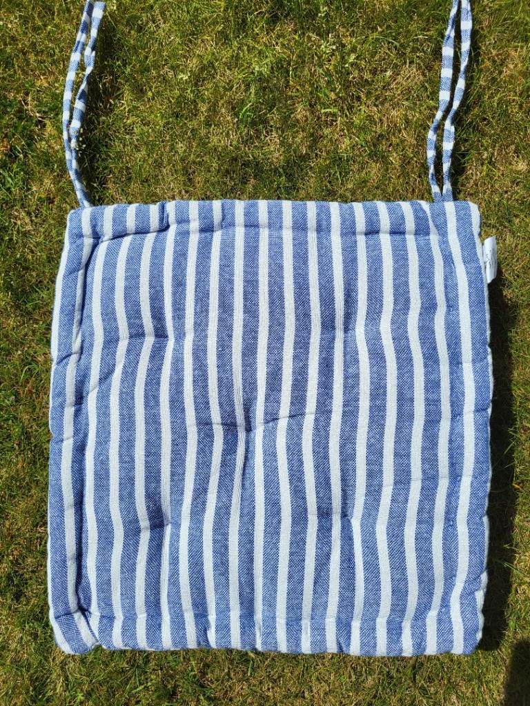 Lovely blue and white stripes seat cushions with ties. 
