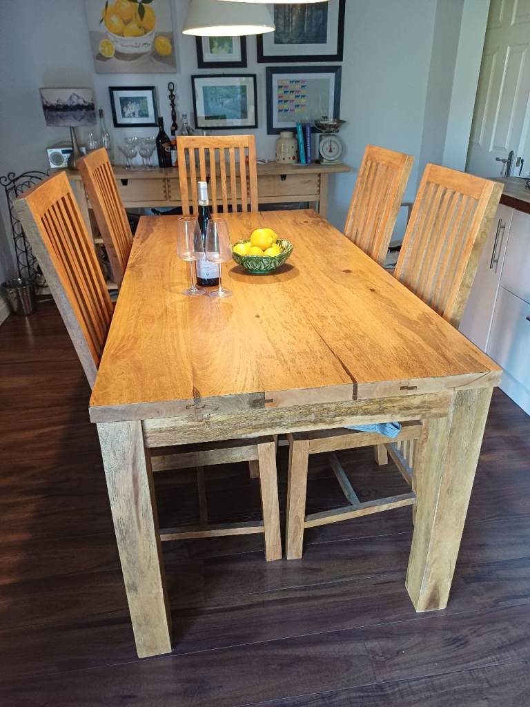 Solid Mango wood dinning room table and 5 chairs.