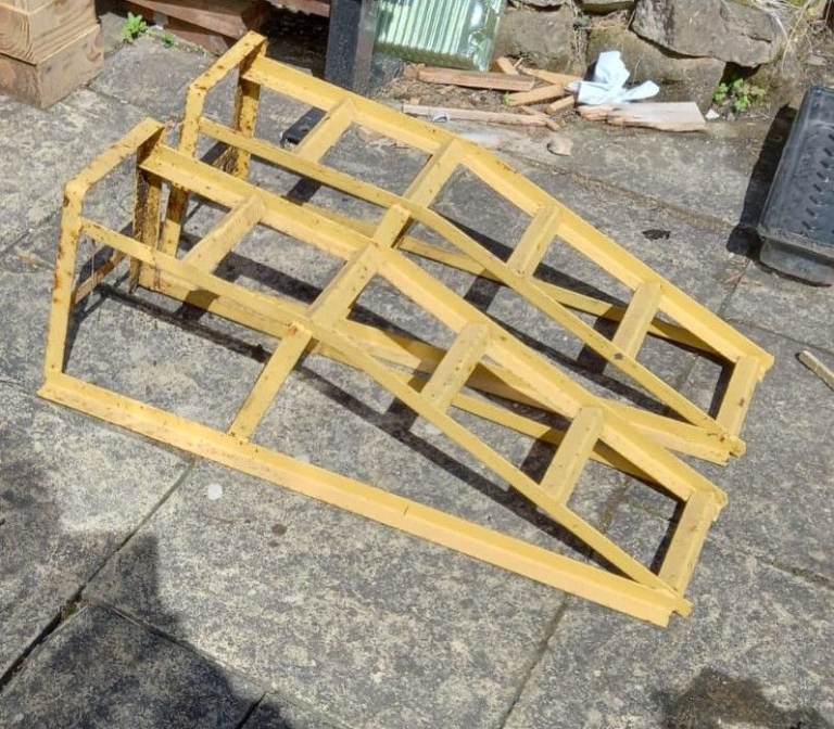  PAIR OF YELLOW CAR RAMPS. VERY STURDY. 32” LENGTH, 11” HEIGHT.