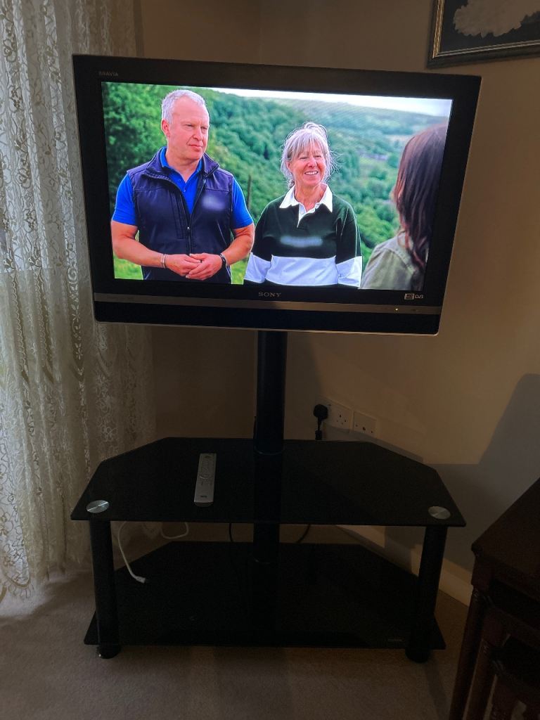 Tv /remote control and black glass stand 38 inches digital 