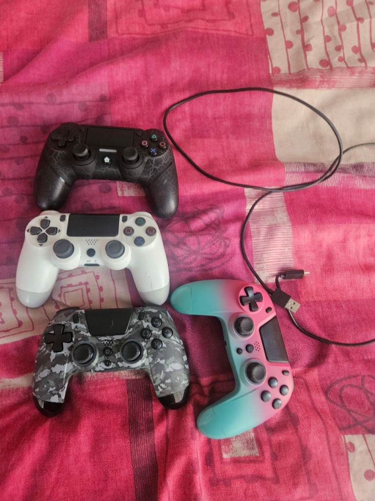 Bundle of Four PS4 Controllers – Black, White, Camo, Pink/Blue