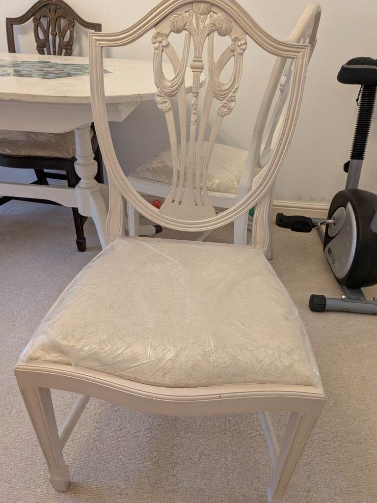 Two traditional wooden feather back dining chairs