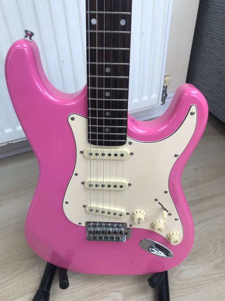 Pink electric strat guitar