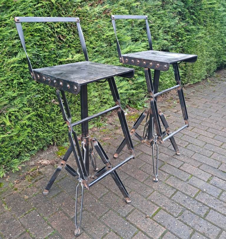 very unusual riveted iron pair of stools