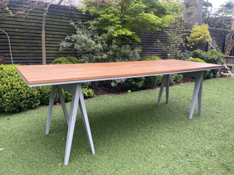 Large walnut Desk/Table with pale grey trestle legs. Cut out for cables