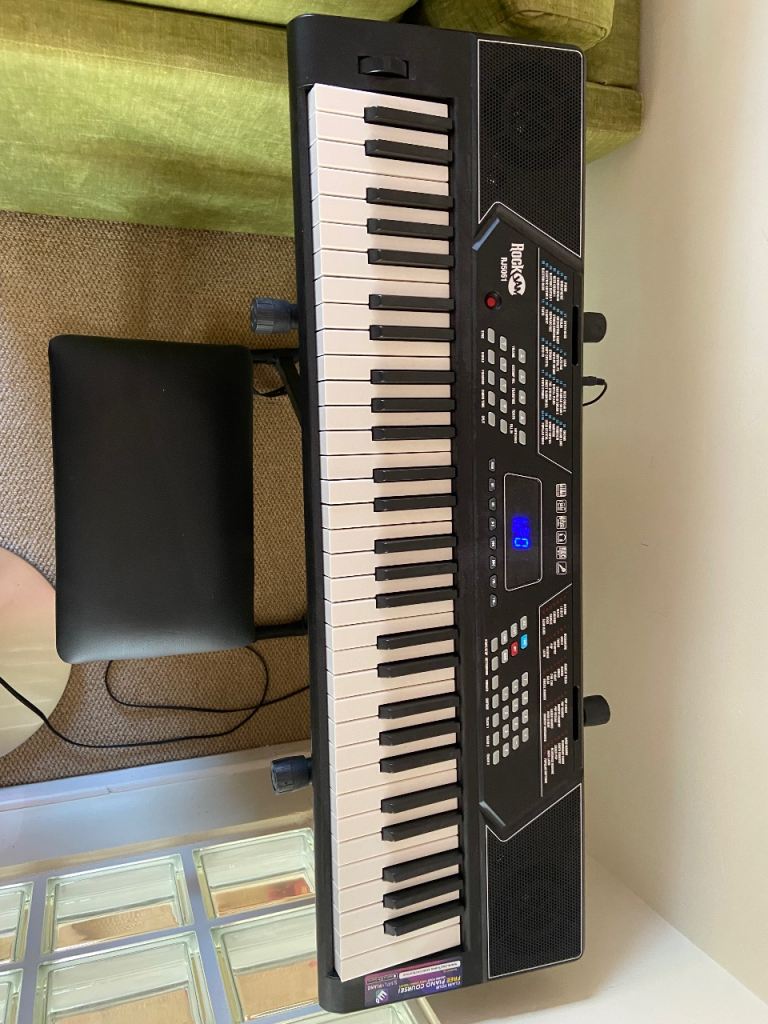 Piano keyboard with stool and book