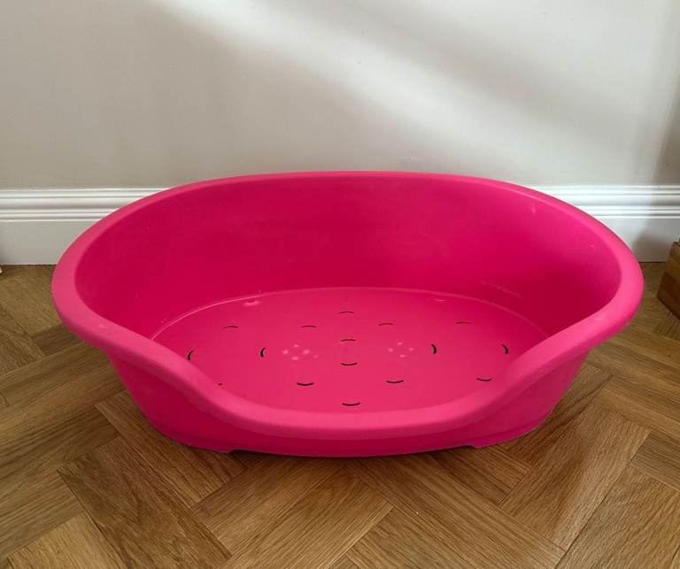 Pink plastic dog bed