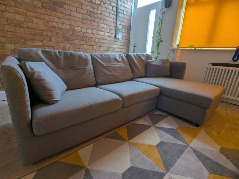 Grey L-shape sofa bed with ample storage