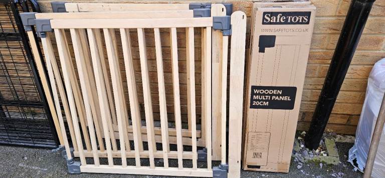 Dog barrier and two unopened extension panels.  Wooden.  