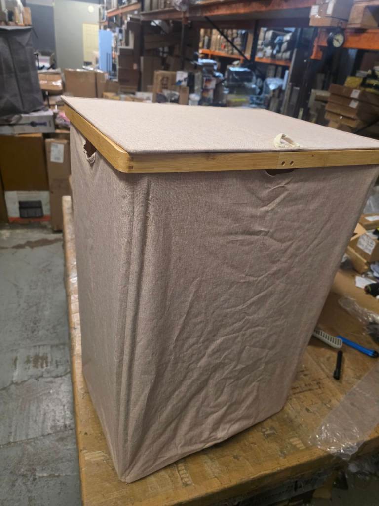 A new large beige folding double laundry hamper. 