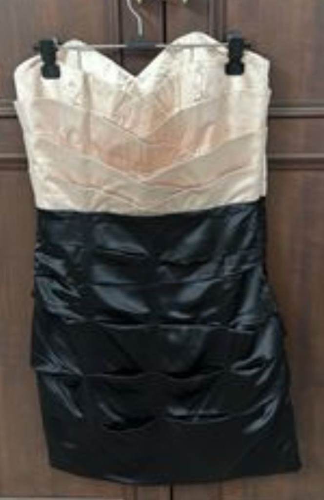 TLipsy brand strapless party dress featuring a peach-colored bodice and a dark gray tiered skirt