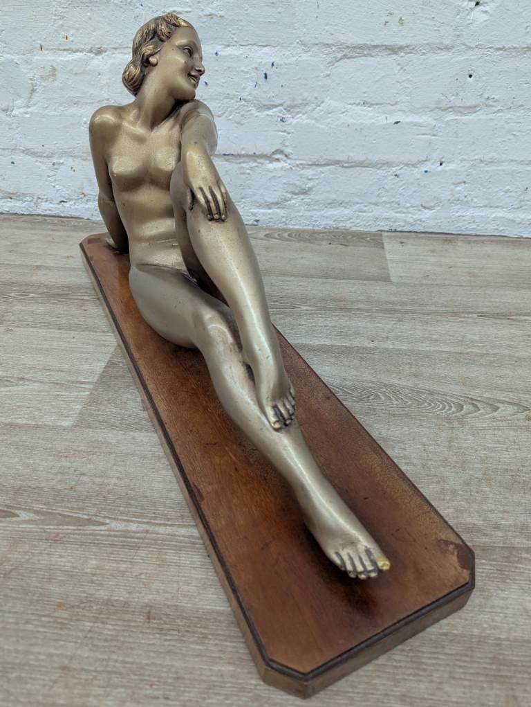 Early 20th century French Art Deco reclining nude figure on wooden plinth