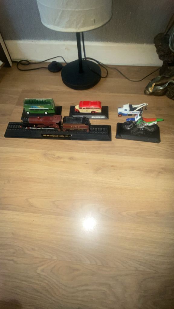 Three Collectible Die-Cast Model Vehicles on Display Bases