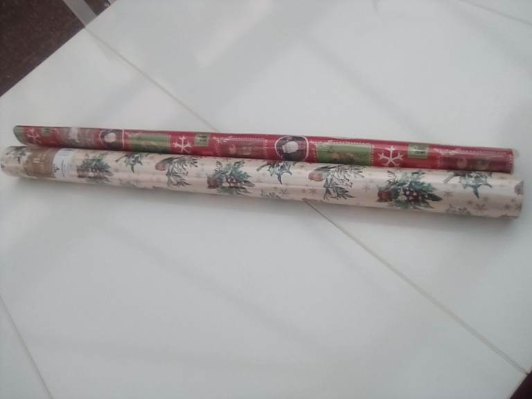2 x unopened rolls of 8m length Christmas wrapping paper.