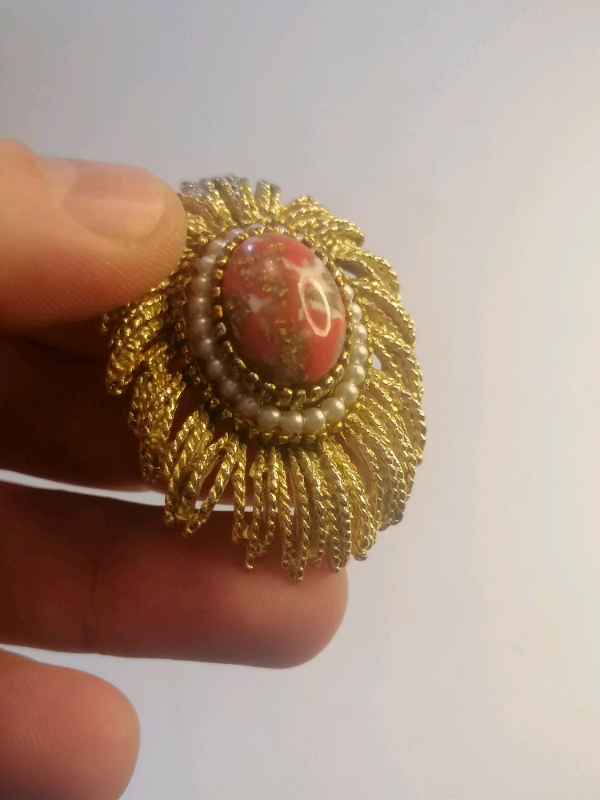 Vintage brooch with red stone inside. 