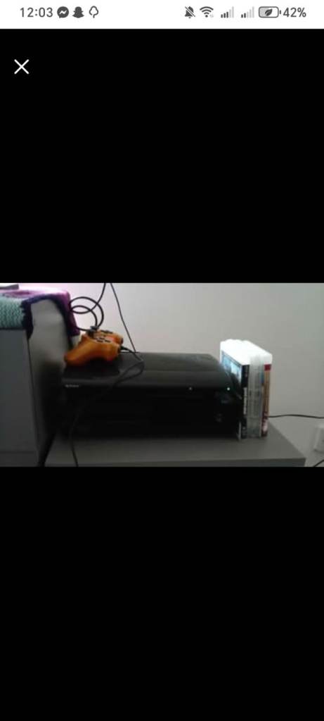 PlayStation 3 with one controller and a couple of games