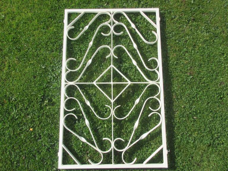 Decorative wrought iron grille with mounting brackets