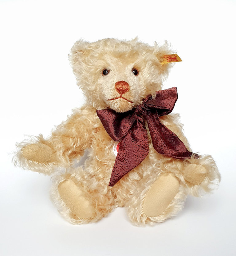 Steiff Bear with Bow and tag with gold plated button. Approx 12 inches