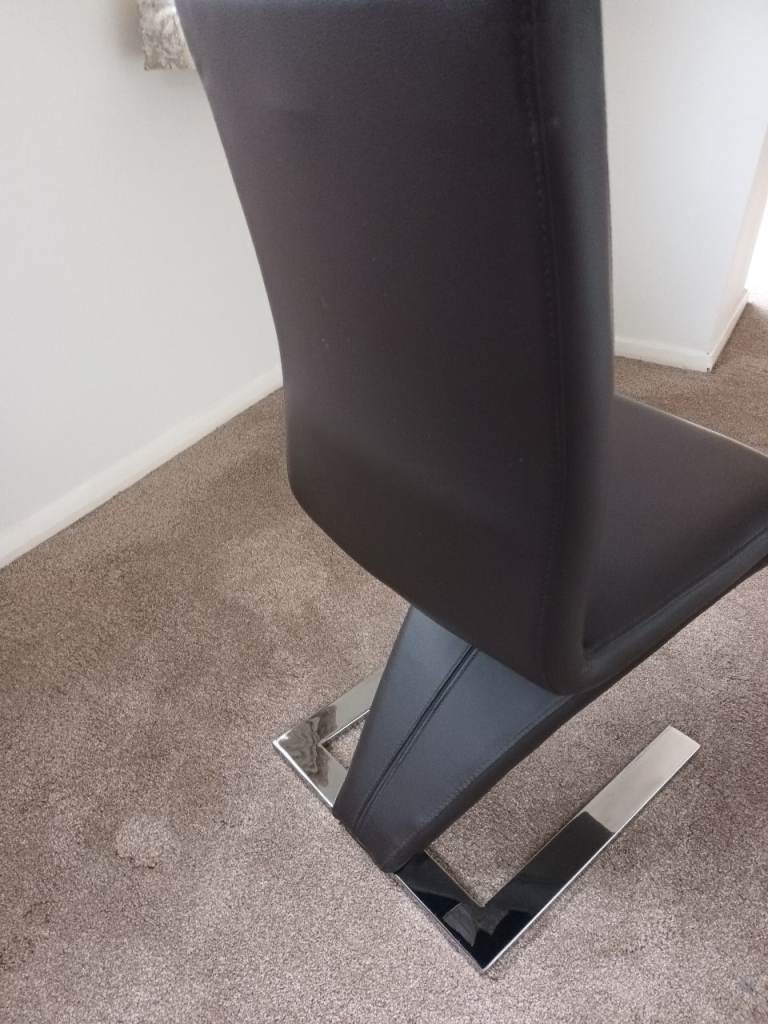 Two(2) brown faux leather cantilever chairs 