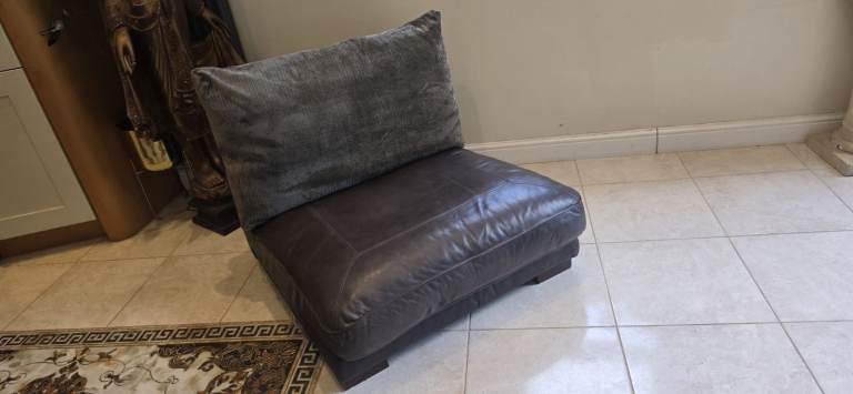 Contemporary modern brown leather armchair chair with flexform back cushion