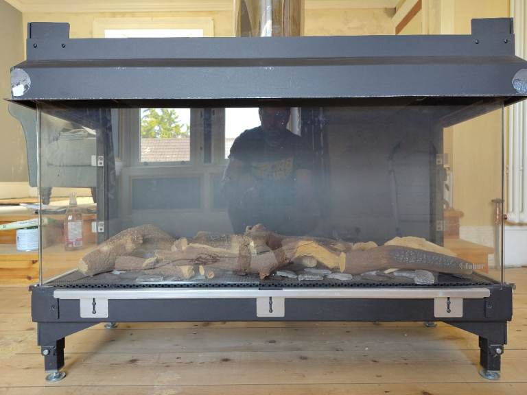 Faber Triple L Smart - Panoramic log-effect fire for media wall installation.