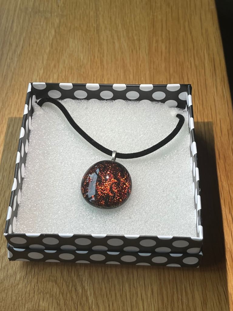 Beautiful dichroic glass pendant on black cord with box. £5