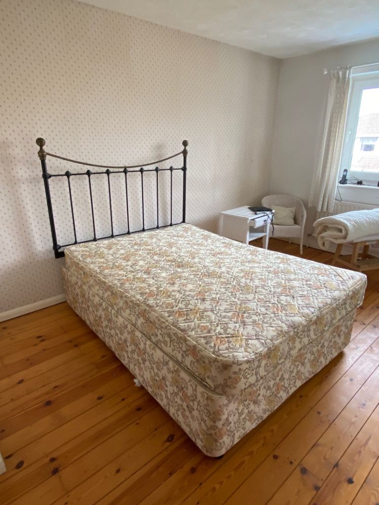 Double bed with black brass style bedstead 