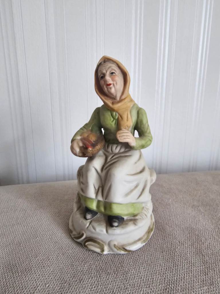 Ceramic figurine Old Lady with vegetable basket sitting on a bench ornament