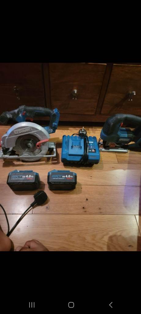 An erbauer circular saw and jigsaw with 2 two batteries and a an 1 one chargers.