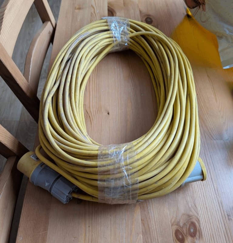A long 50m yellow heavy duty extension lead with three-pin industrial plugs.
