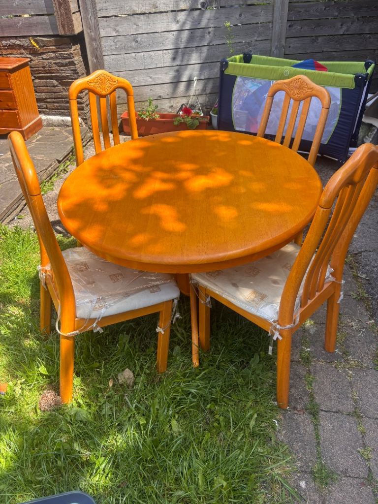 Round wood dining table and 4 chairs. Teak?