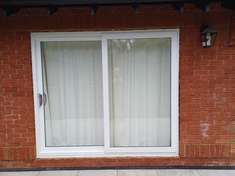 Eurocell White Sliding Patio Doors.  Approximately 5 years old