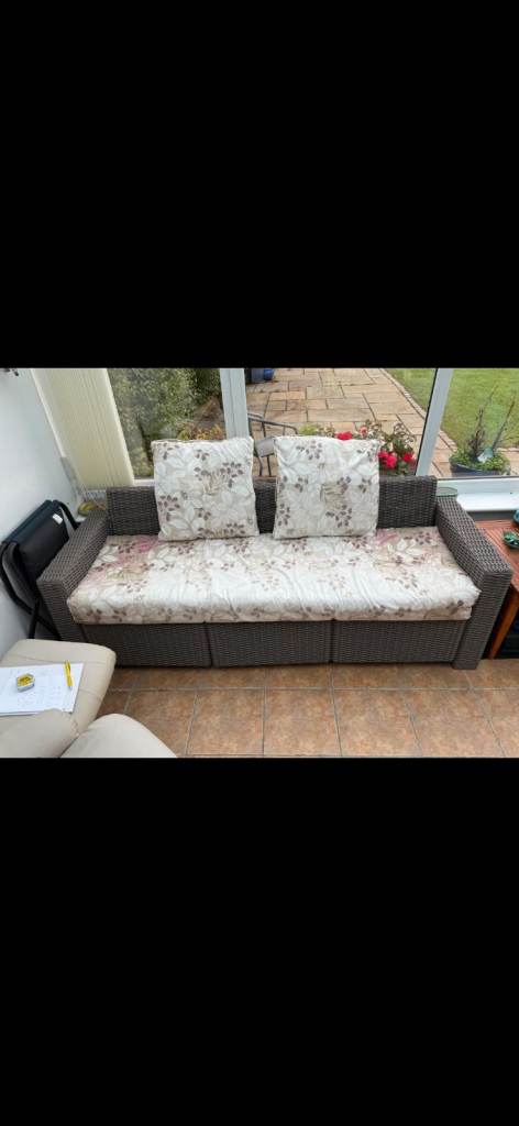 Comfortable Grey Sofa Bed with Floral Cushions – Good Condition