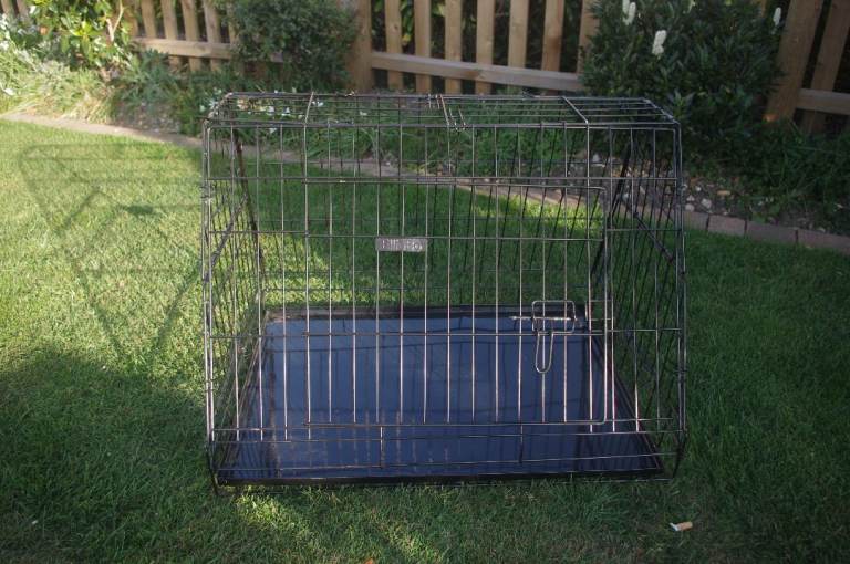 Foldable dog crate ideal for transporting pet in the car. 