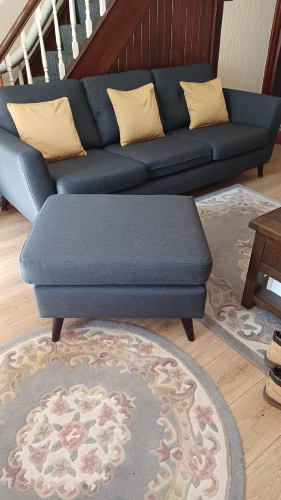 Grey fabric three seater settee