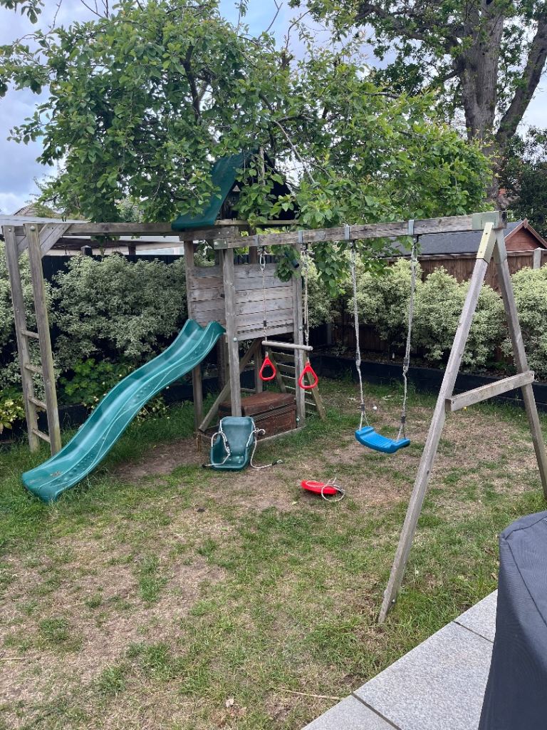 Climbing frame with swings and slide