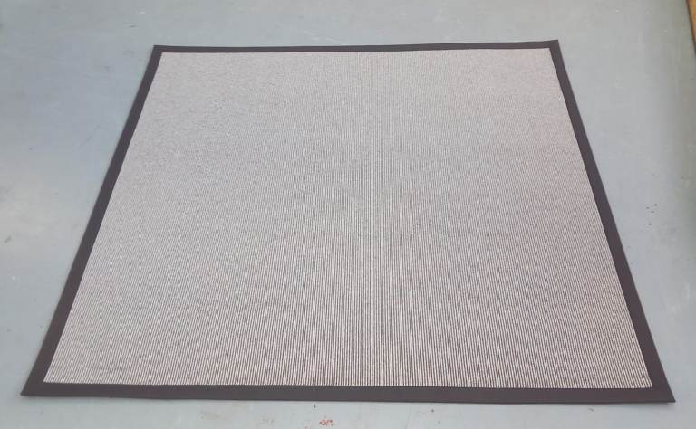 light grey ribbed rug with a dark grey border