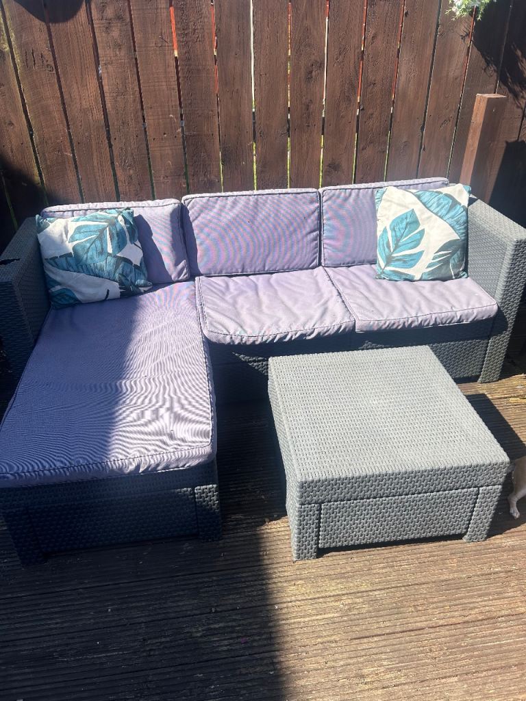 Outdoor sofa with cushions and table