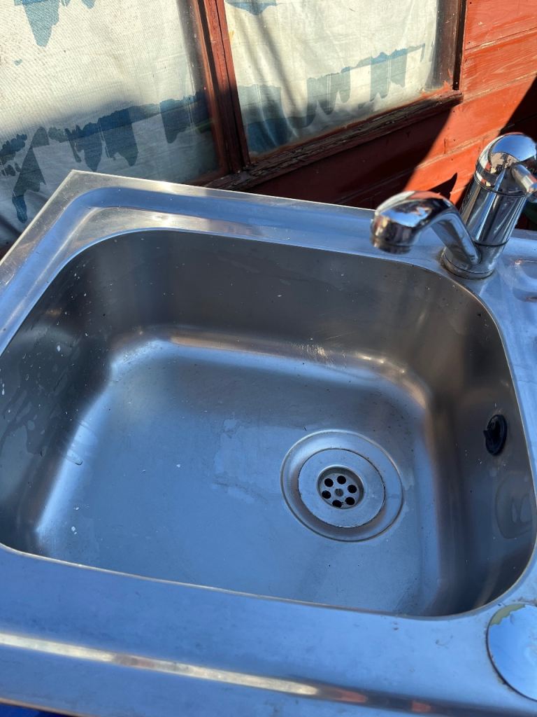 Kitchen sink with tap