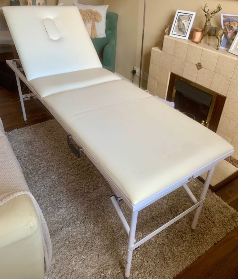 Cream beauty/massage plinth with black carry case.