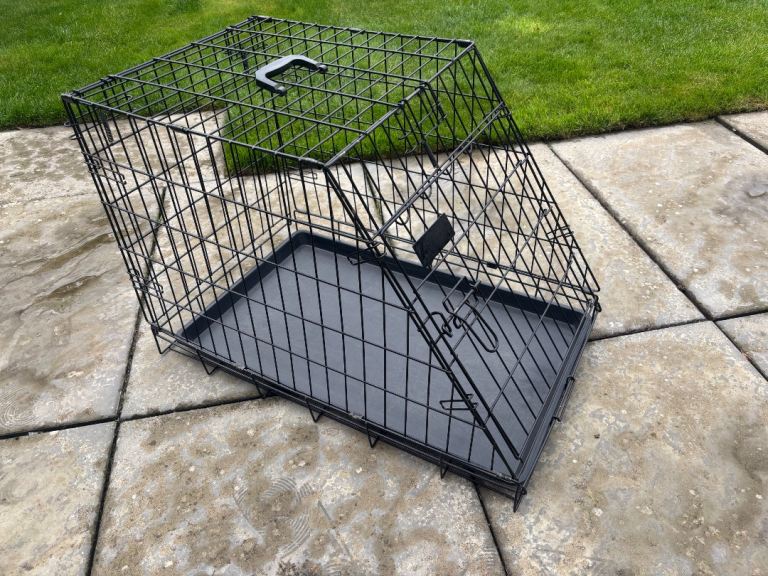 Black metal dog crate with plastic tray, folds flat for storage